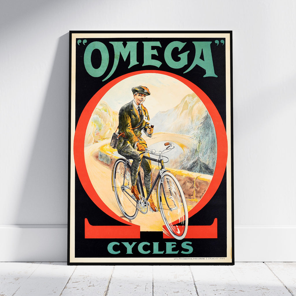 A framed vintage-style poster leaning against a white wall on a light floor. The poster reads "OMEGA CYCLES" and shows an illustrated man riding a bicycle inside a large red circle on a black background.