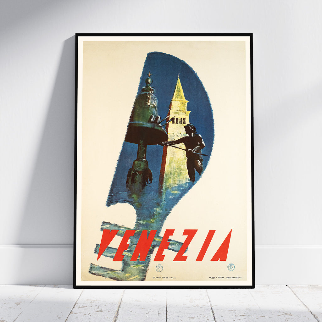 A framed vintage-style travel poster for Venezia leaning against a white wall on a light wood floor. The poster features a large number 9 shape in blue and cream tones, with a gondola and a gondoler carrying a lantern, and the word 'VENEZIA' in large red letters at the bottom.