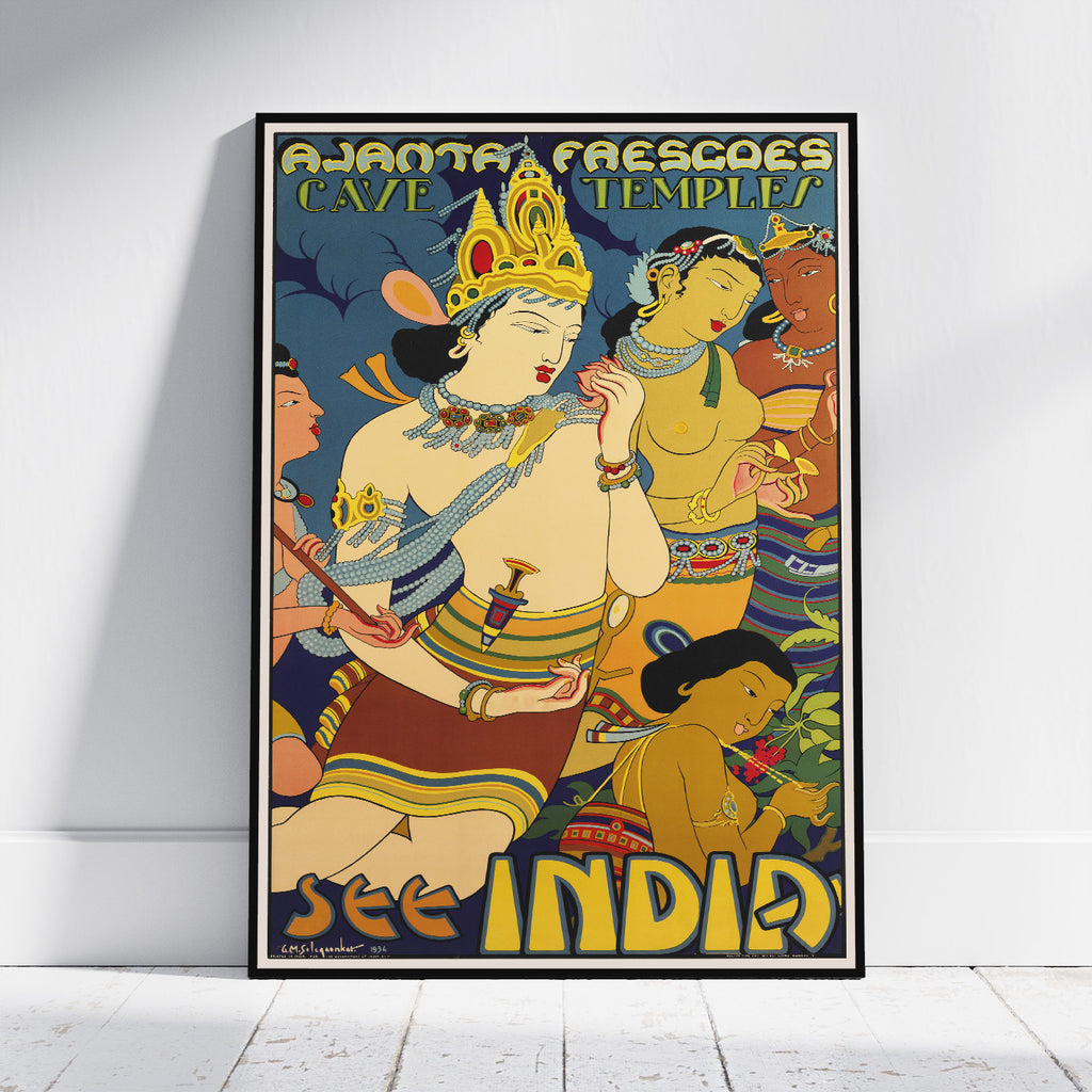 A framed vintage-style travel poster leaning against a white wall on a light floor. The poster features stylized figures in warm yellow, tan, red, and blue tones with large text reading 'AJJANTA FRESCOS CAVE TEMPLE' at the top and 'SEE INDIA' at the bottom.