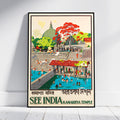 A framed travel poster of Kamakhiya Temple in Rameswaram, India, leaning against a white wall on a light wood floor. The poster features a retro-style illustration with a green stupa, a red-leafed tree, and people swimming in the blue water of the temple pool, with text reading 'SEE INDIA KAMAKHIYA TEMPLE'.