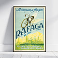 A framed vintage-style travel poster leaning against a white wall on a light floor. The poster features a bicycle with wings, the text 'La campeona de Aragón', 'RAFAGA NO CORRE.