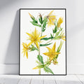 A framed botanical art print featuring yellow flowers and green leaves on a white background, leaning against a light gray wall on a white wooden floor.