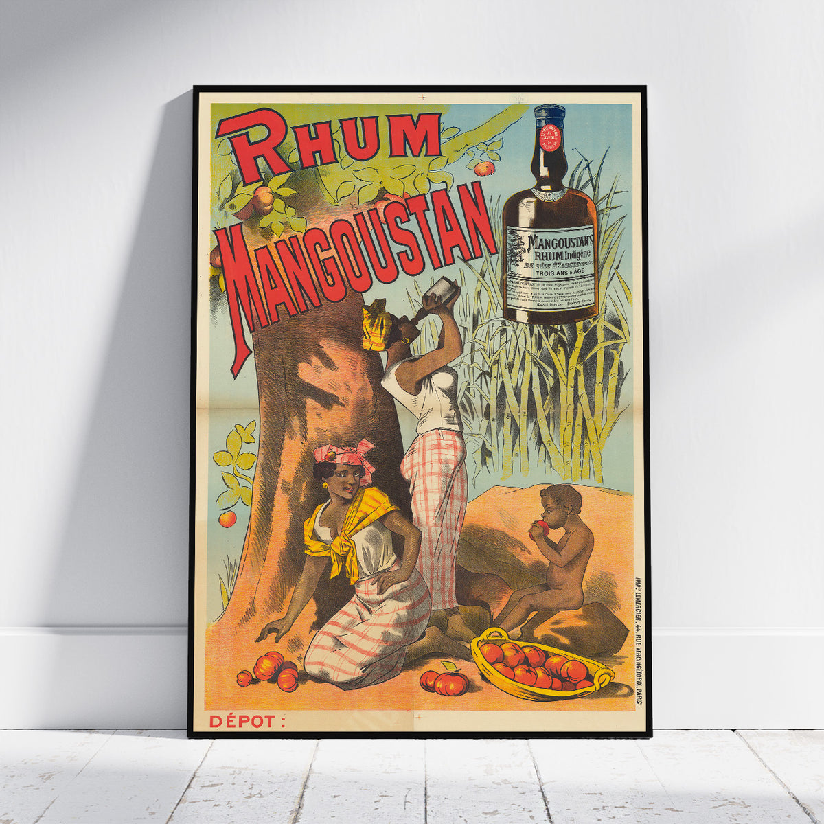 A framed vintage advertising poster for 'Rhum Manguistan' leaning against a white wall on a light wood floor. The poster features a colorful illustration with a large bottle, workers, fruit, and sugarcane, with the brand name 'MANGUISTAN' visible on the bottle graphic.