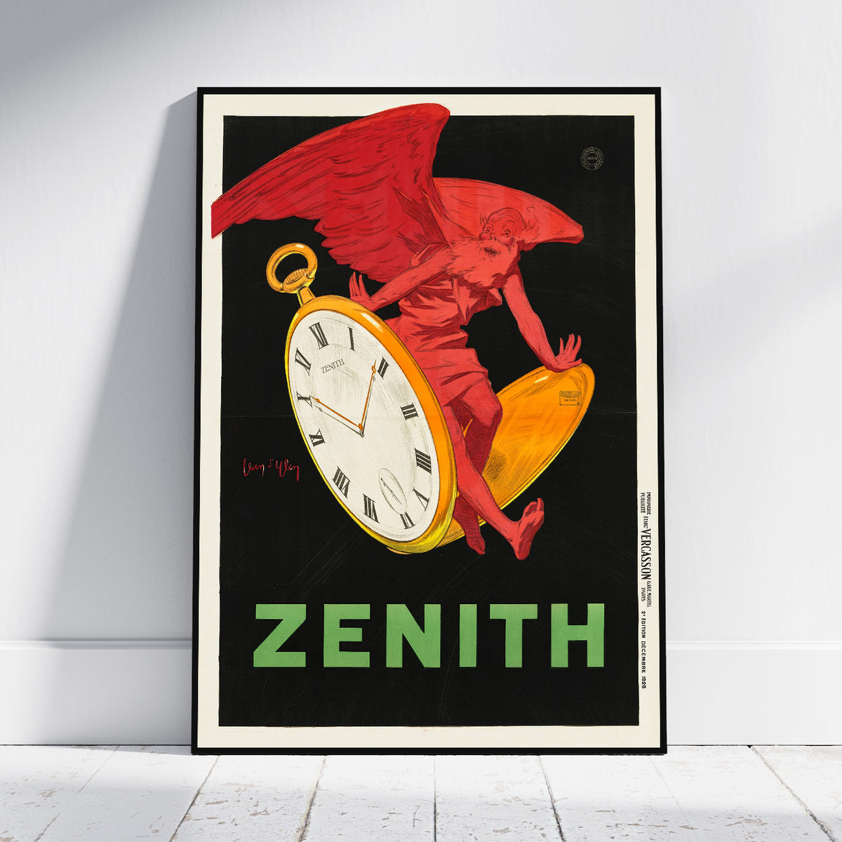 A framed vintage Zenith pocket watch poster leaning against a white wall on a light wood floor. The poster features a red winged figure holding a large gold pocket watch against a black background, with the word 'ZENITH' in green at the bottom.