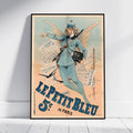 A framed vintage-style poster leaning against a white wall on a light wood floor. The poster features an illustrated woman in a blue uniform with wings, holding a rifle and a camera, with large blue text reading 'LE PETIT BLEU 5  de PARIS' on a warm cream background.