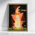 A framed vintage-style poster leaning against a white wall on a light floor. The poster features an Art Nouveau illustration of a woman with dark hair and a red hat, holding a glowing lamp bulb, with the text 'Lampe' and 'WESTINGHOUSE' in yellow.