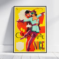 A framed vintage-style poster leaning against a white wall on a light wood floor. The poster features a colorful illustration of a woman in a teal and purple outfit with a large red-and-white skull figure behind her, set on a bright yellow background.