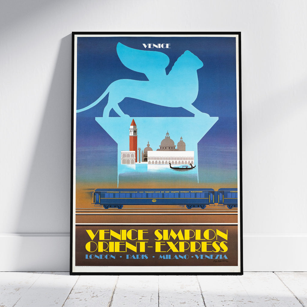 A framed vintage-style travel poster leaning against a white wall on a light wood floor. The poster features a blue winged lion silhouette above Venice landmarks, with a blue train on tracks and yellow text reading 'VENICE SIMPLON ORIENT-EXPRESS' and 'LONDRAN PARIS - MIANG - VENECIA'.