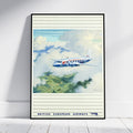 A framed vintage-style poster leaning against a white wall on a light wood floor. The artwork shows a blue, white, and red British European Airways airplane flying through clouds above green fields.