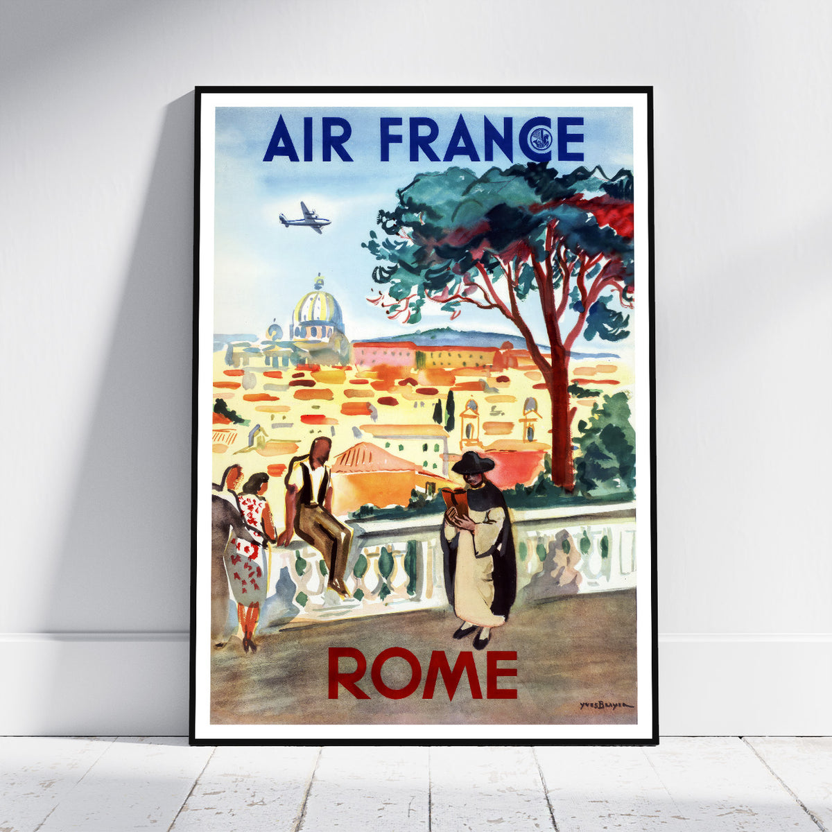 A framed vintage-style Air France travel poster leaning against a white wall on a light floor. The poster features an illustrated cityscape labeled 'AIR FRANCE' at the top and 'ROME' at the bottom, with people, a large tree, buildings, and an airplane.