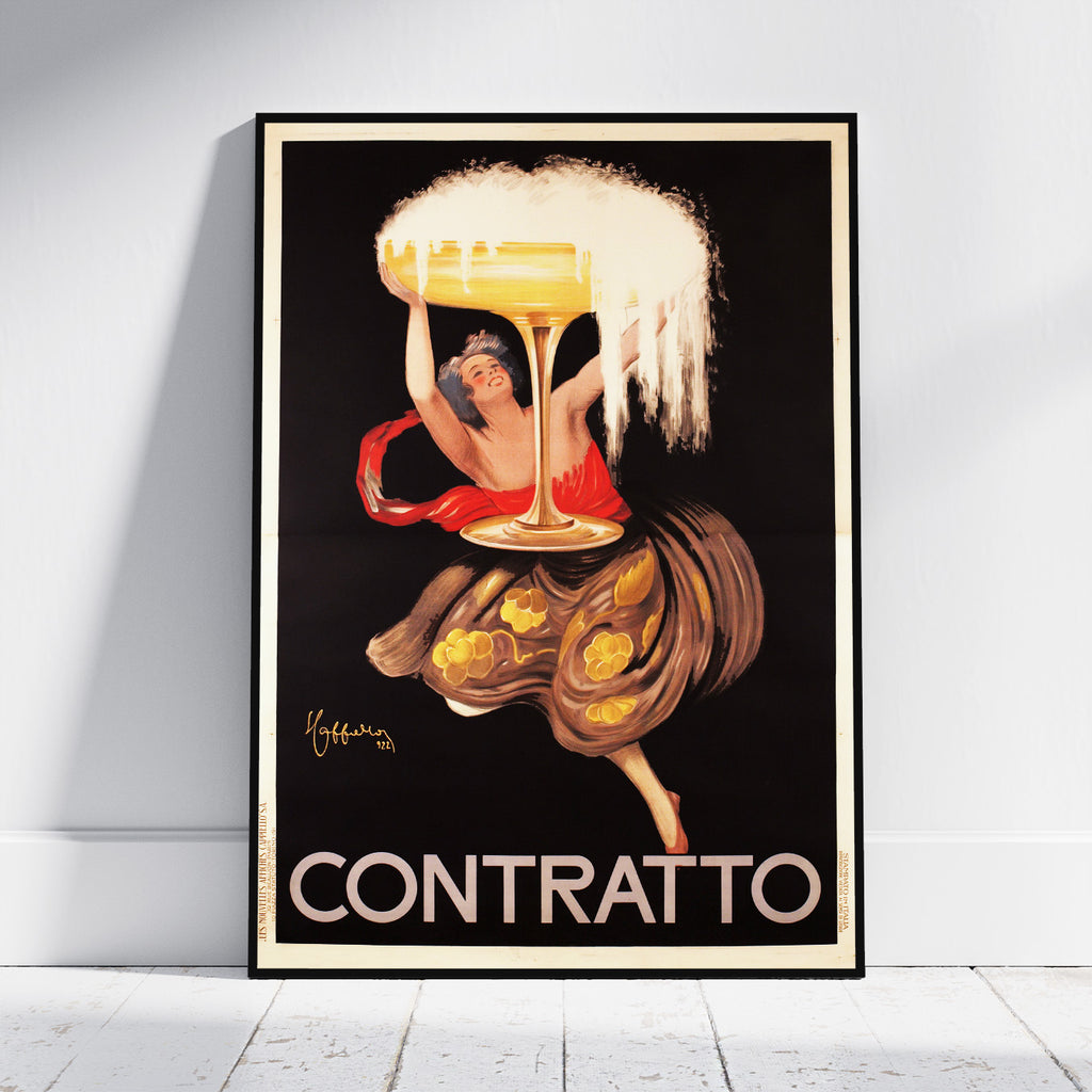 A framed vintage-style poster leaning against a white wall on a light wood floor. The artwork shows a woman in a red dress holding a large golden drink glass above the word 'CONTRATTO' in bold cream letters on a black background.