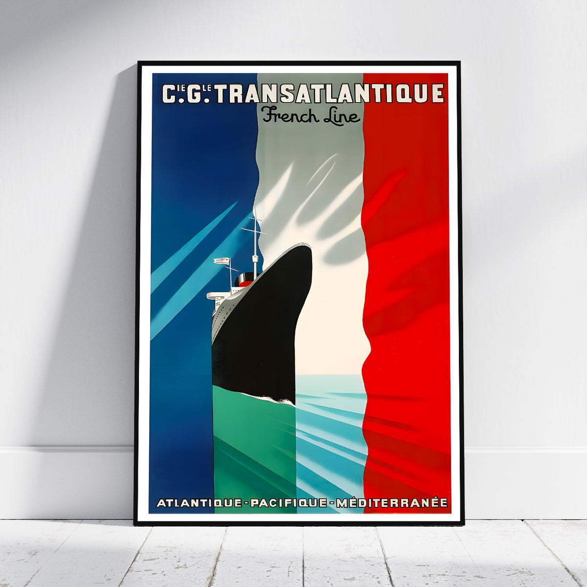 A framed vintage-style travel poster leaning against a white wall on a light floor. The poster features a large ship cutting through vertical blue, white, and red stripes, with French text reading 'C.