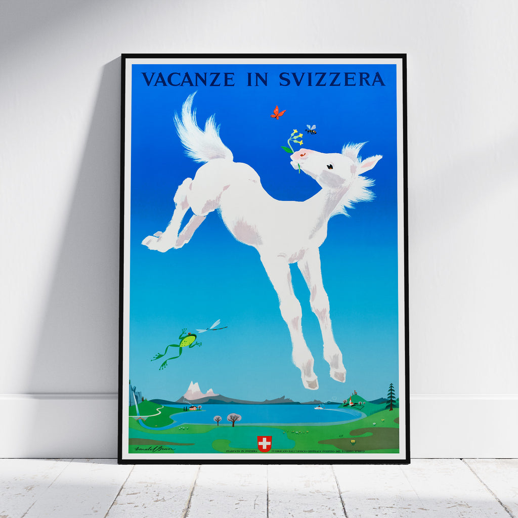 A framed travel poster featuring a whimsical white horse jumping against a bright blue sky, with the text 'VACANZE IN SVIZZERA' at the top and a small Swiss flag near the bottom. The poster is displayed leaning against a white wall on a light wood floor.