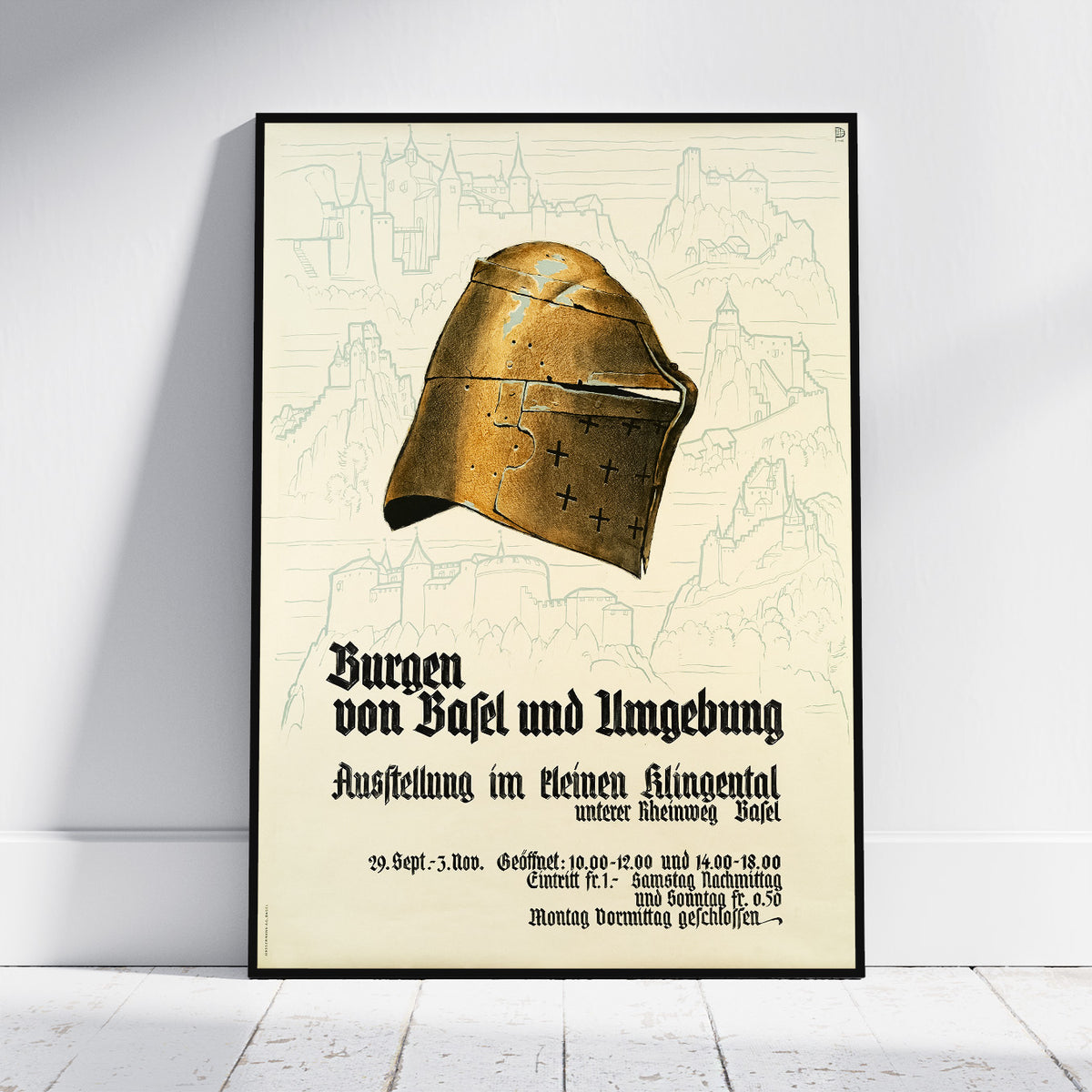 A framed vintage-style poster leaning against a white wall on a light wood floor. The poster features a large medieval-style bronze helmet illustration above German text, with faint castle sketches in the background.