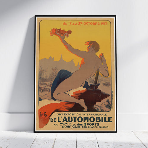 A framed vintage-style poster leaning against a white wall on a light floor. The poster artwork shows a reclining nude woman holding a red car, with French text and the title 'XIV Exposition Internationale de l'Automobile'.
