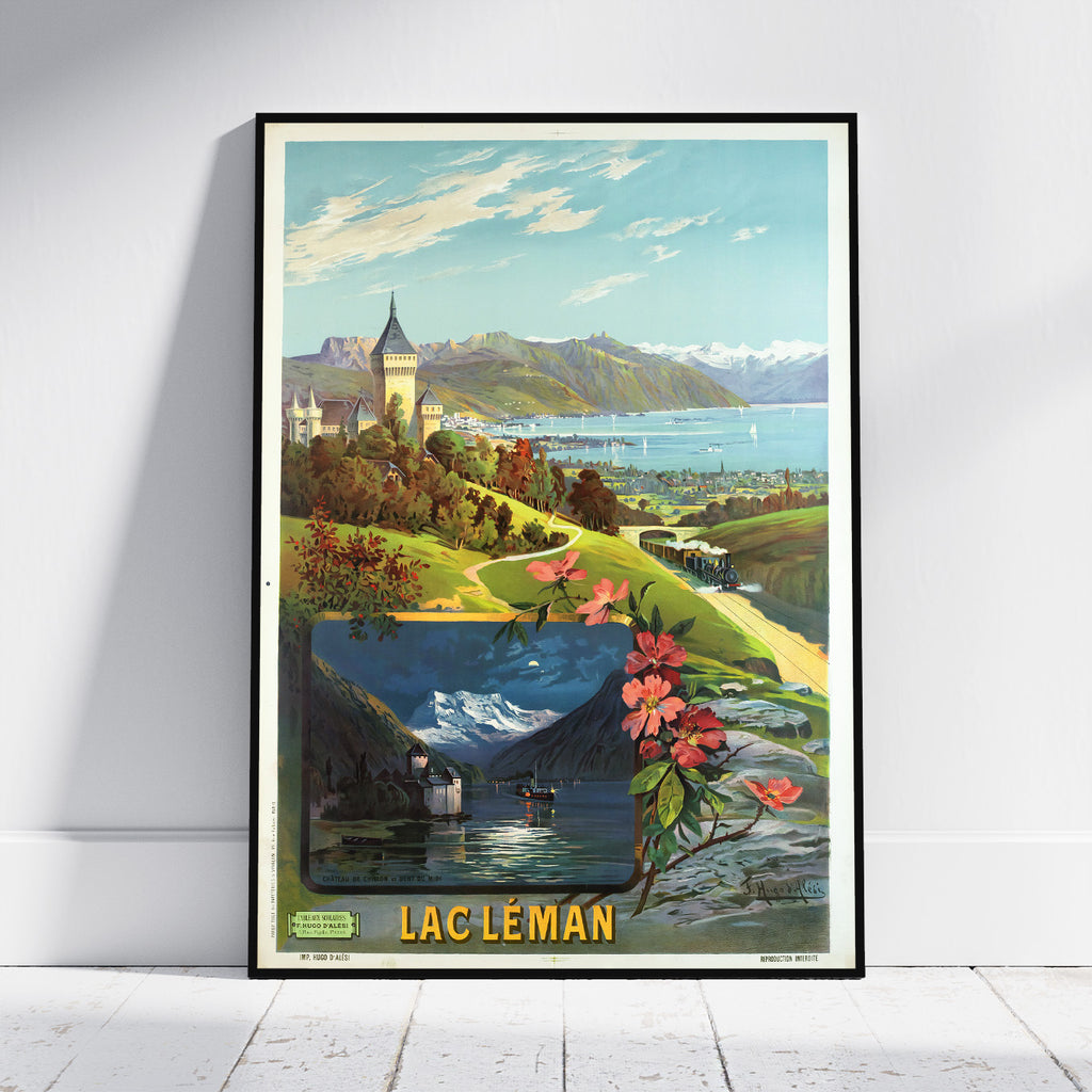 A framed vintage travel poster of Lac Léman, Quebec, leaning against a white wall on a light wood floor. The poster features a colorful illustration of a scenic lake landscape with mountains, a train, and pink flowers in the foreground, with 'LAC LÉMAN' printed in bold yellow letters at the bottom.