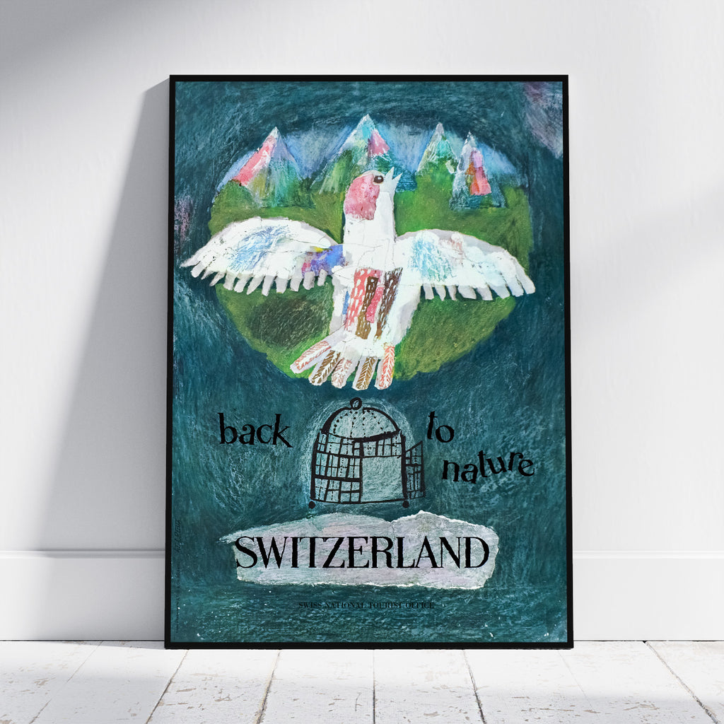 A framed art print leaning against a white wall on a light floor. The artwork shows a white bird with pink and blue accents flying over green hills and mountains, with the text 'back to nature' and 'SWITZERLAND' on a dark teal textured background.