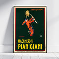 A framed vintage-style poster leaning against a white wall on a light floor. The poster features an illustration of a person tossing spaghetti in the air, with the text '.