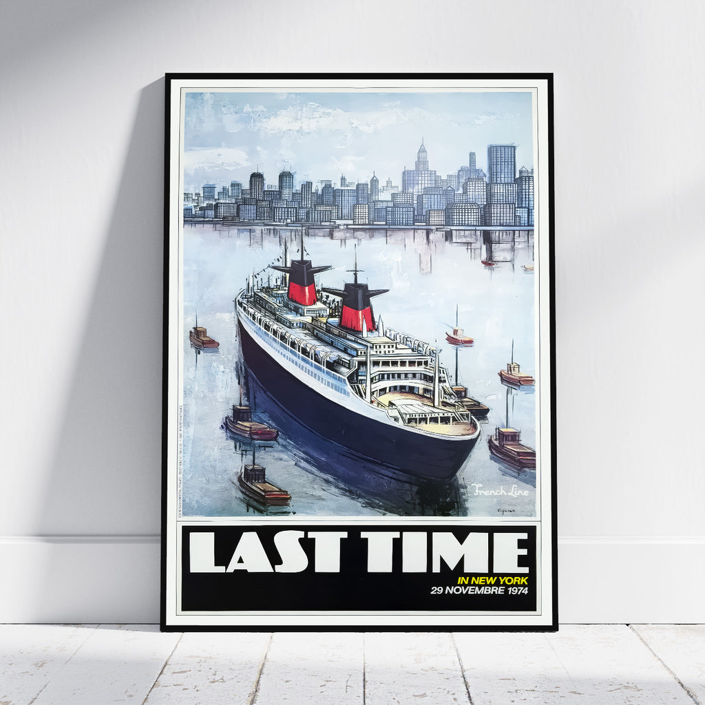 A framed vintage-style travel poster leaning against a white wall on a light floor. The artwork shows a large ocean liner in blue water with a city skyline in the background and bold text reading “LAST TIME” at the bottom.