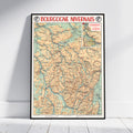 A framed vintage-style map poster titled 'BOURCOGNE NIVERNAIS' leaning against a white wall on a light wood floor. The map features beige terrain, blue river lines, and red title text.
