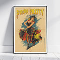 A framed vintage-style poster leaning against a white wall on a light floor. The poster shows a woman in a black dress with red, yellow, and blue floral accents and the text 'Francine Pretty' at the top.