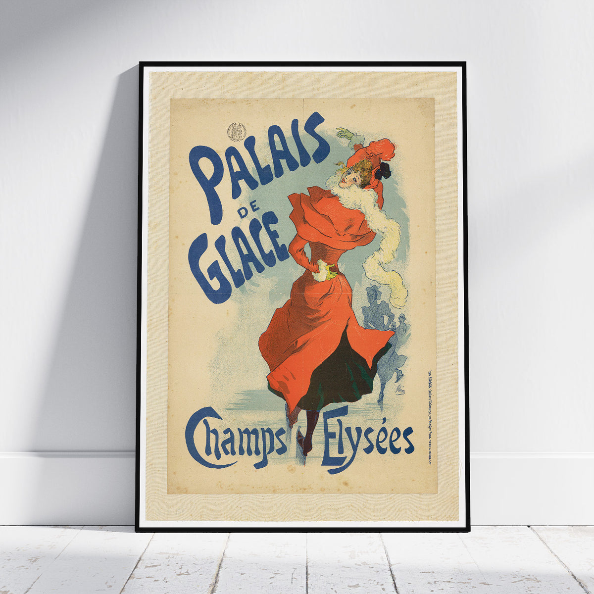 A framed vintage-style poster leaning against a white wall on a light floor. The poster shows an illustrated woman in a flowing red dress and hat with large blue text reading 'PALAIS DE GLACE' and 'Champs-Flyscées'.