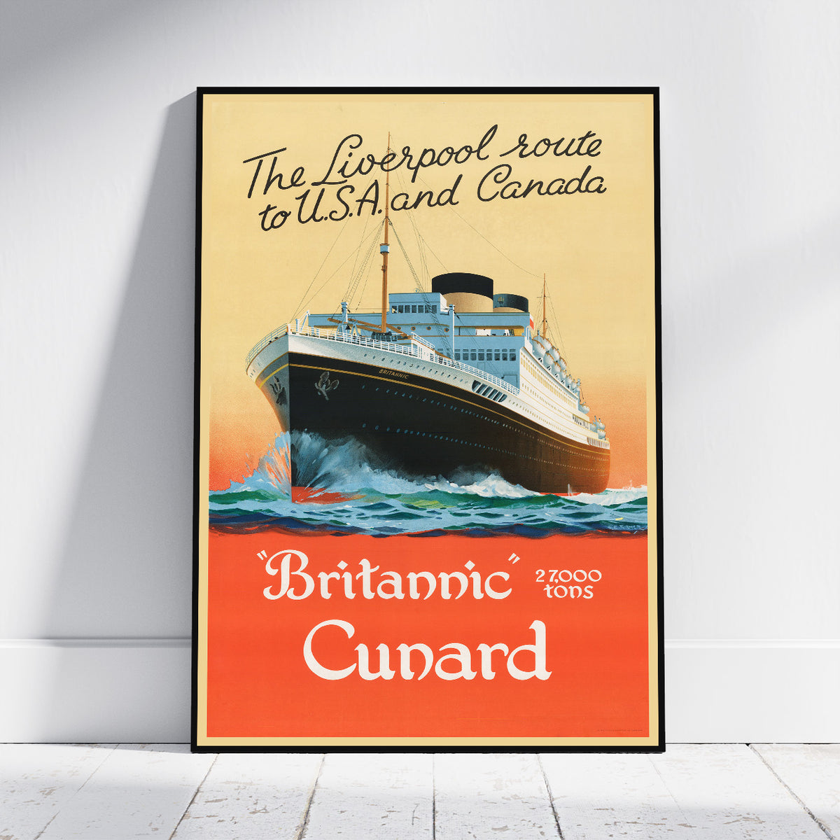 A framed vintage-style travel poster leaning against a white wall on a light wood floor. The poster shows a large ocean liner rising from the sea, with the text 'The Liverpool route to U.