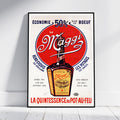 A framed vintage-style poster for Le Maggi hot sauce leaning against a white wall on a light wood floor. The poster features a large red circle with the white Maggi script, a bottle illustration, and French text including 'Economie 50% sur le boeuf' and 'La quintessence du pot-au-feu'.