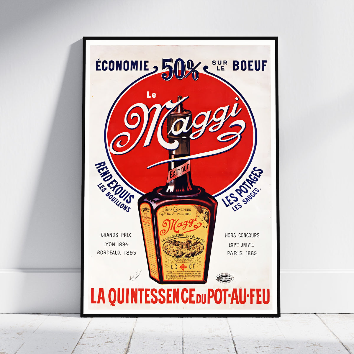 A framed vintage-style poster for Le Maggi hot sauce leaning against a white wall on a light wood floor. The poster features a large red circle with the white Maggi script, a bottle illustration, and French text including 'Economie 50% sur le boeuf' and 'La quintessence du pot-au-feu'.