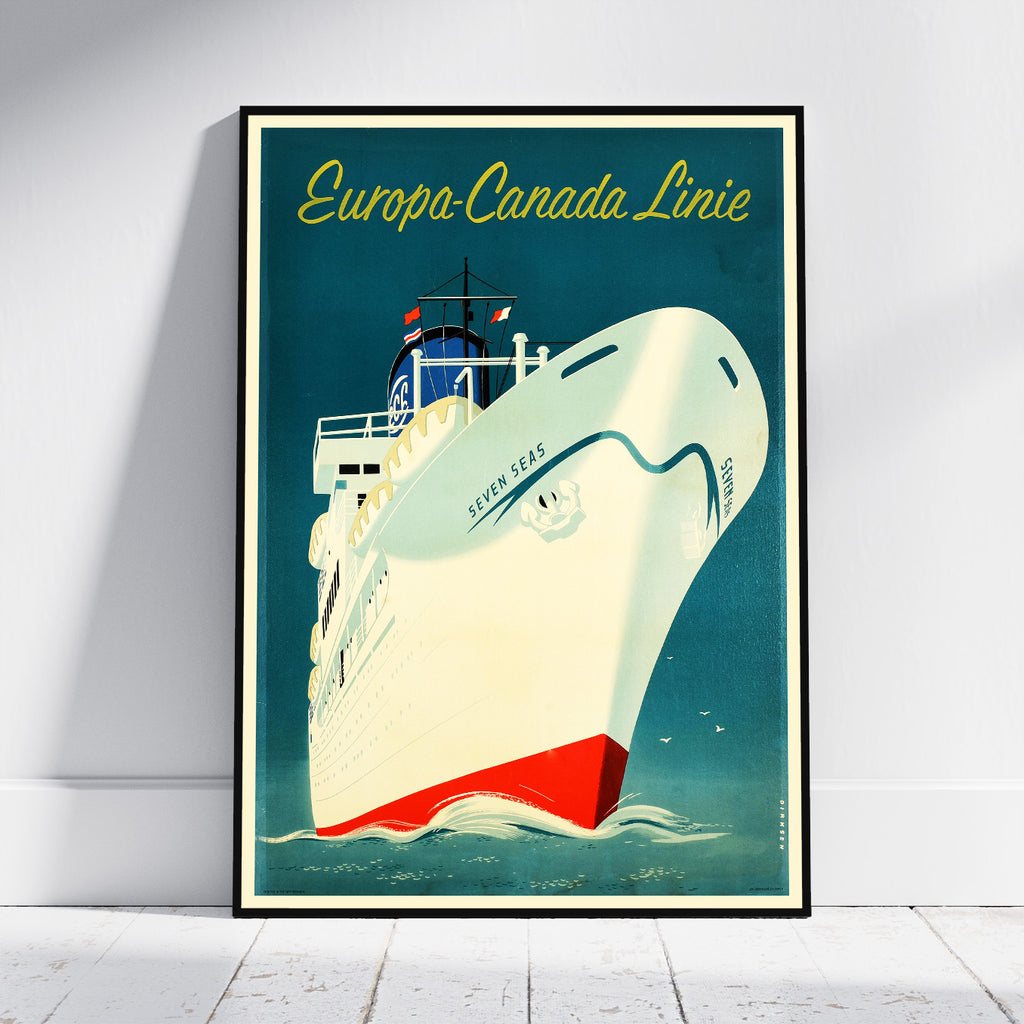 A framed vintage-style travel poster leaning against a white wall on a light floor. The poster shows a large cream-colored ocean liner with a red hull and yellow text reading 'Europa-Canada Linie' against a teal-blue background.