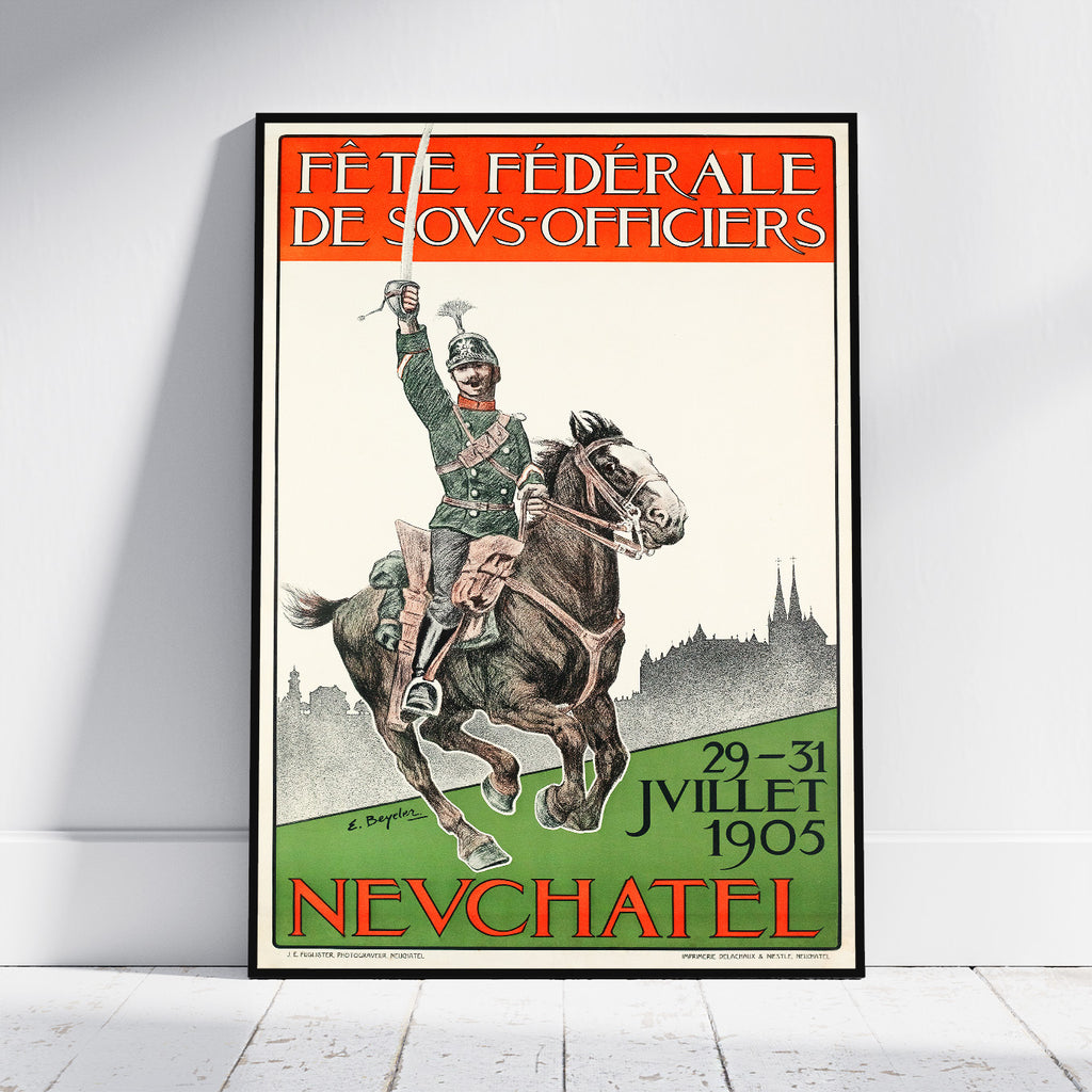 A framed vintage French military poster leaning against a white wall on a light wood floor. The poster features an illustration of a soldier on a galloping horse with the text 'FÉTE FÉDÉRALE DE S.