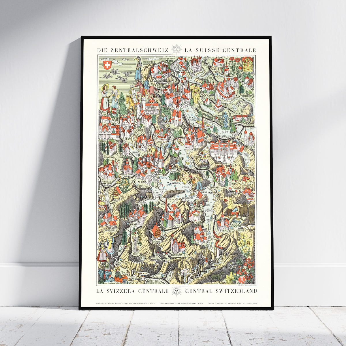 A framed vintage-style map poster of Central Switzerland (DIE ZENTRALSCHWEIZ / LA SUISSE CENTRALE) leaning against a white wall on a light wood floor.