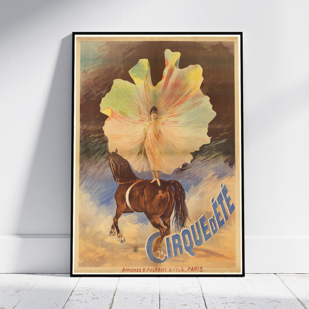 A framed vintage-style poster leaning against a white wall on a light floor. The artwork shows a large pale flower-like form with a small figure inside, a brown horse below, and the word 'CIRQUEGÉTÉ' in blue.