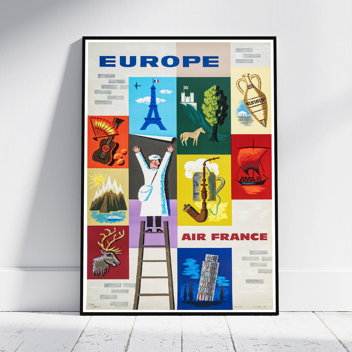 A framed vintage-style Europe travel poster with colorful illustrated landmarks and the text 'EUROPE' and 'AIR FRANCE', leaning against a white wall on a light floor.
