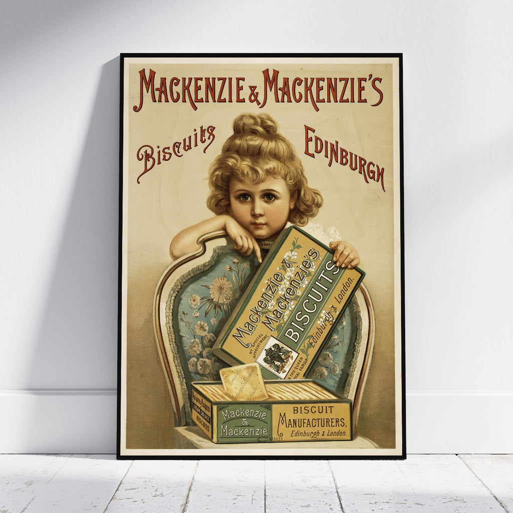 A framed vintage-style advertising poster leaning against a white wall on a light floor. The poster shows a young girl holding a box of MacKenzie & Mackenzie's Biscuits, with large decorative text reading 'Mackenzie & Mackenzie's Biscuits Edinburgh.