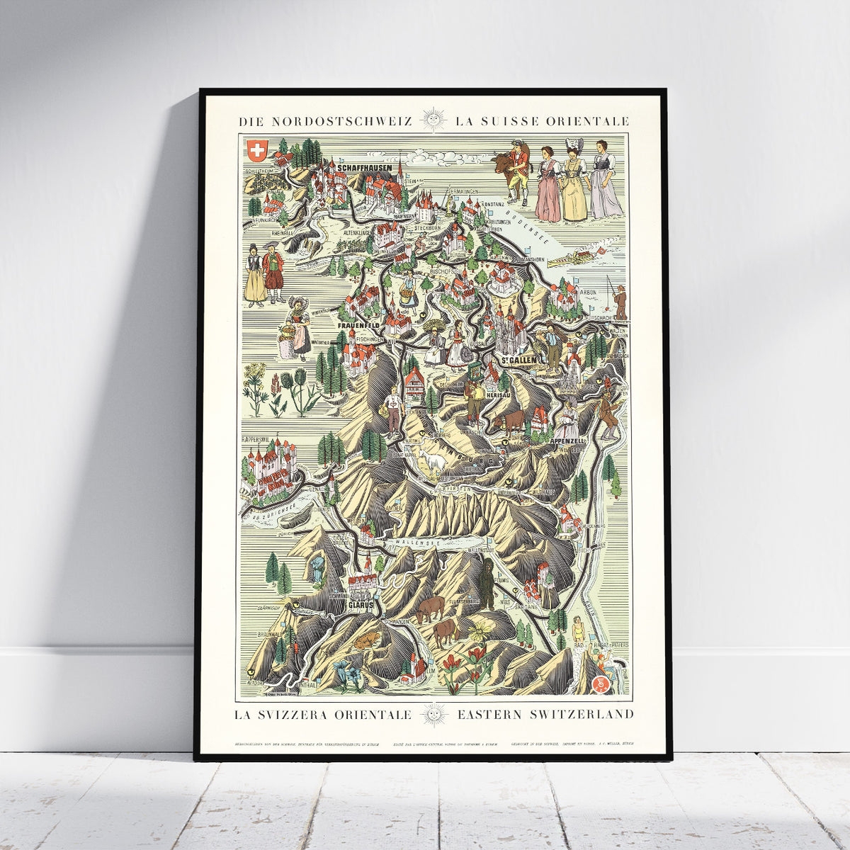 A framed vintage-style map poster of Eastern Switzerland ('Die Nordostschweiz / La Suisse Orientale') leaning against a white wall on a light wood floor.