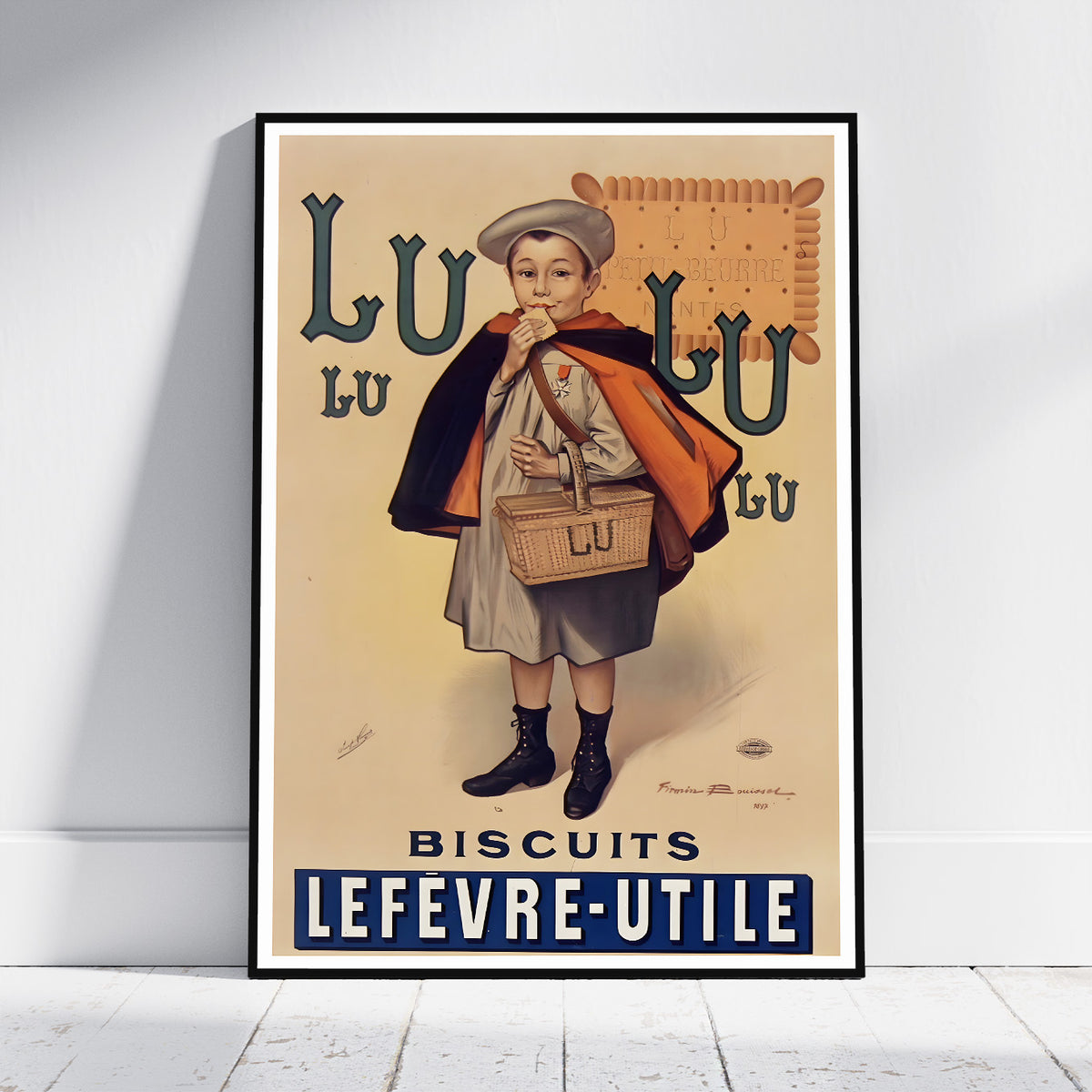 A framed vintage-style poster leaning against a white wall on a light wood floor. The poster shows an illustrated child holding a basket of biscuits with large text reading 'LU LU LU LU BISCUITS LEFEVRE-UTILE'.