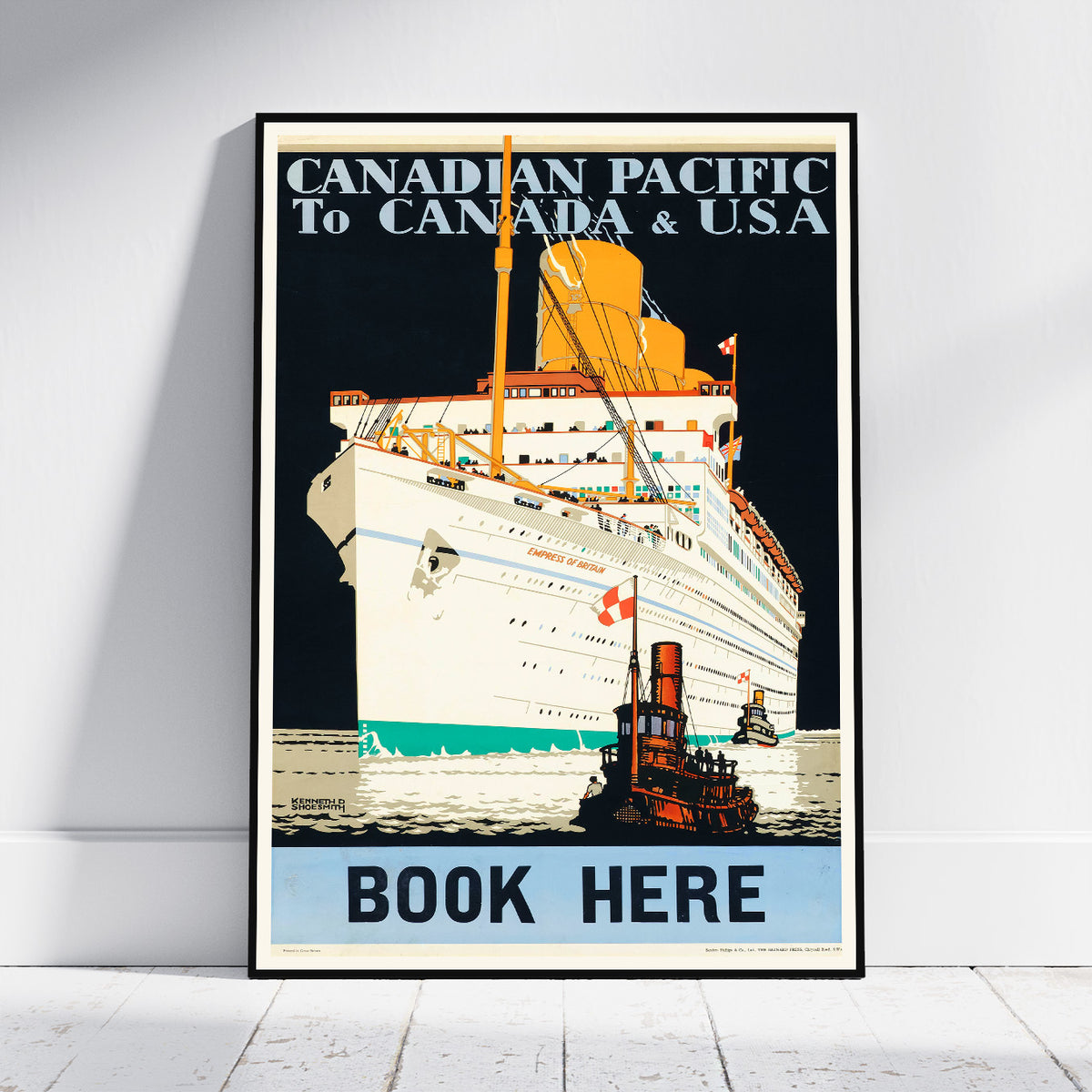 A framed vintage travel poster for the Canadian Pacific Railway, leaning against a white wall on a light wood floor. The poster features an illustration of a large ocean liner and a tugboat, with text reading 'CANADIAN PACIFIC TO CANADA & USA' and 'BOOK HERE'.