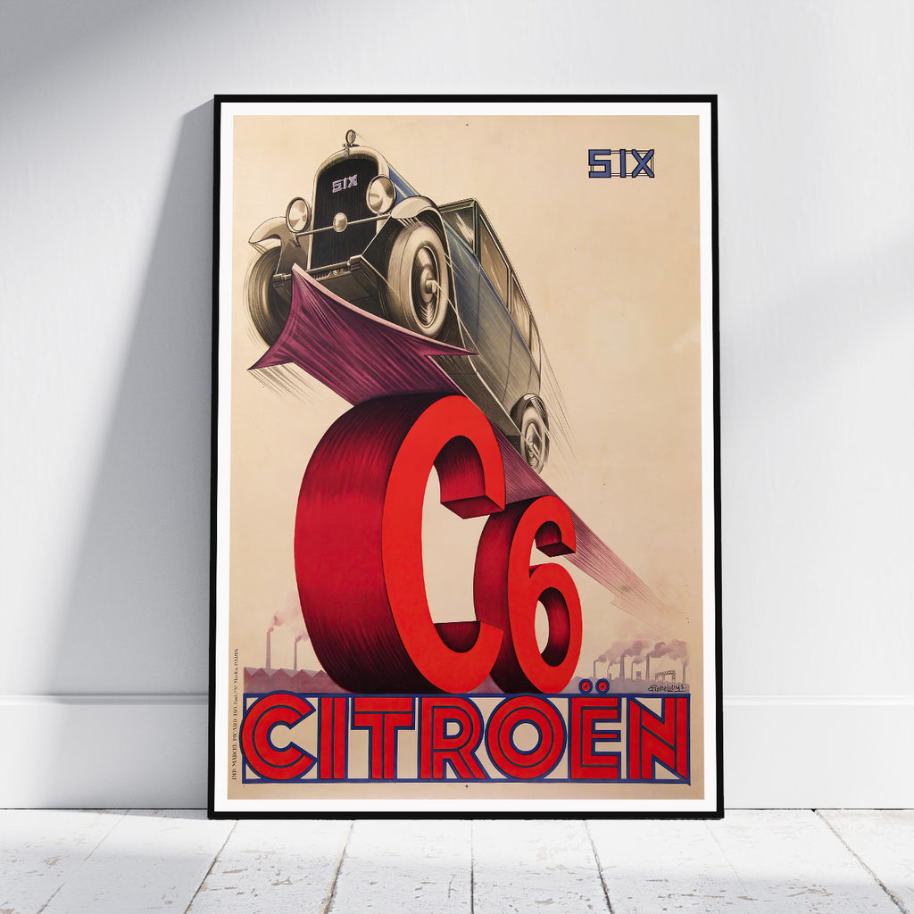 A framed vintage-style Citroón poster leaning against a white wall on a light floor. The artwork shows an old car above a large red 'C6' and 'CITROØN' text on a beige background, with 'SIX' in the upper right.