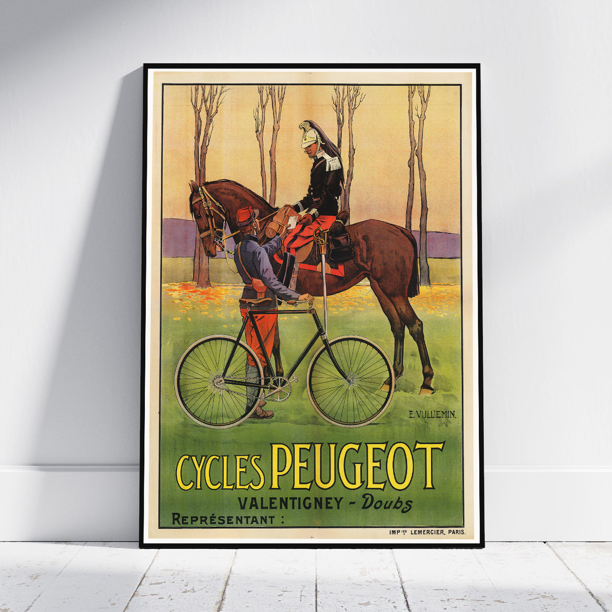 A framed vintage poster print leaning against a white wall on a light floor. The poster shows an illustrated scene with a horse, rider, bicycle, and large text reading 'CYCLES PEUGEOT' with 'VALENTIGNY - Doubs' and 'REPRÉSENTANT'.