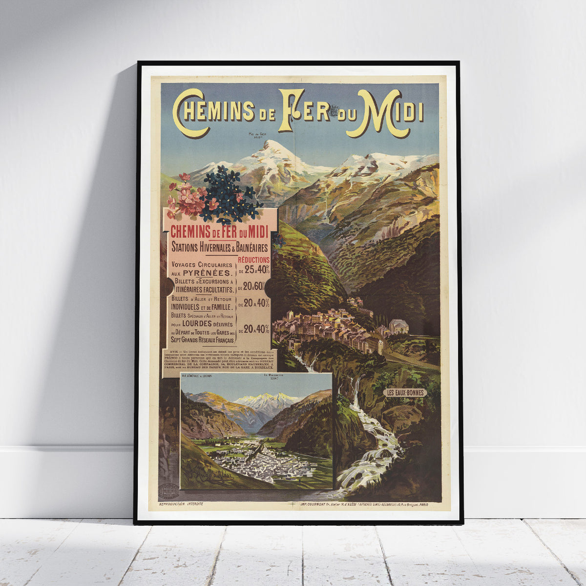 A framed vintage travel poster for 'Chemin de Fer du Midi' leaning against a white wall on a light wood floor. The poster features a scenic mountain landscape with a train station, a waterfall, and a train station in Grenoble, with French text and an illustrated landscape.