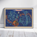 A framed art print leaning against a white wall on a white wooden floor. The print features a vintage-style map of France and surrounding countries in teal and orange on a dark blue background, with a globe graphic at the bottom and a banner reading 'AIR FRANCE' at the top.